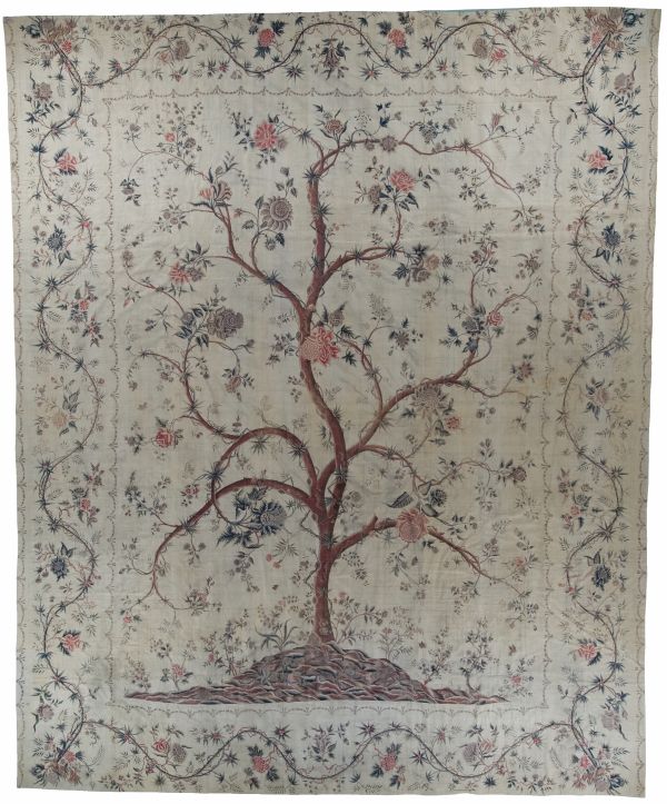 historic textile of a tree on a beige background with flowers and vines