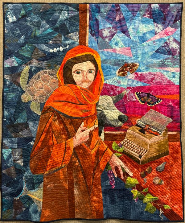 Susan Yanos - From the Webs She Wove Sprang Life (quilt of a woman in an orange robe with images floating around--a turtle, cow, butterflies, fish, and typewriter)