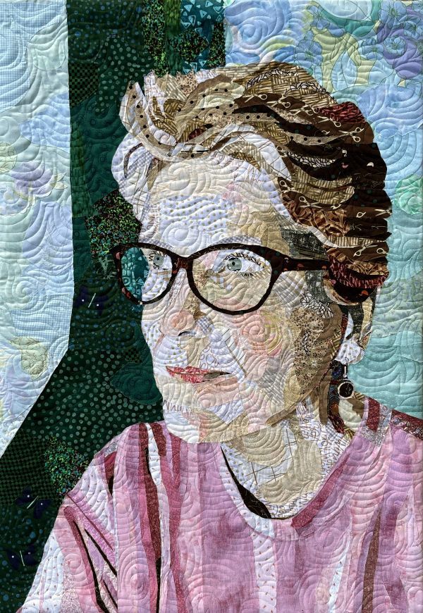 Karol Kusmaul - Pieces of Me (A quilted portrait of a woman with short hair and glasses. She is gazing towards the left)