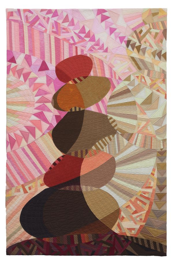 Vicki Conley - Rock Cairn #2 (quilt showing a rock cairn on a background of pink and tan triangles and stripes)