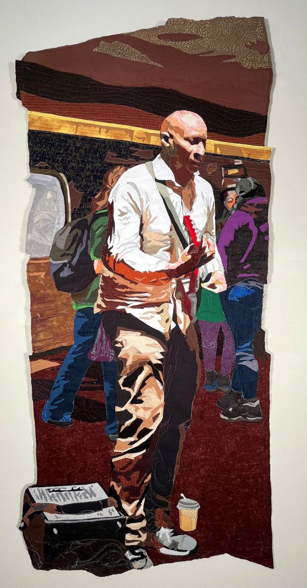 Jayne Bentley Gaskins - Subway Musician (quilted portrait of a man playing electric guitar in a crowded subway station)