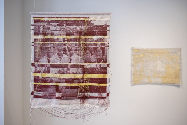 Thương Hoài Trần - Kỷ Niệm Ngày Cưới: Burgundy and Gold (textile wall hanging of photos printed in burgundy on white fabric with lots of handing threads and bands of yellow)