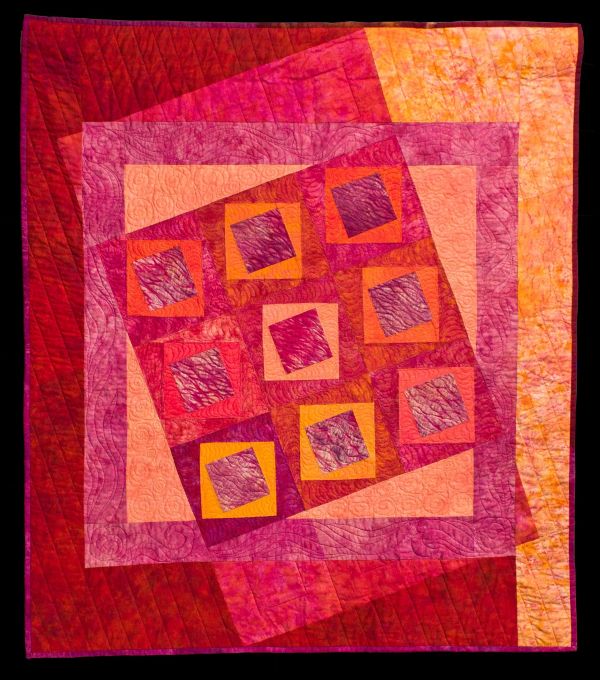 Kindy Kemp - The East Is Red (a quilt with red and orange background and red and orange squares)