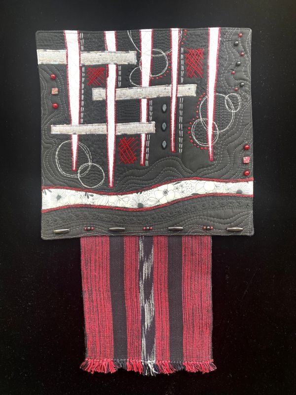 Heidi Zielinski - Sparks In The Dark (black white and red art quilt incorporating weaving remnants)