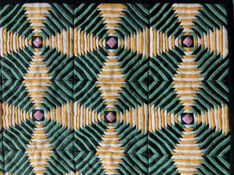 Amy Pabst -  Windmill Blades (a geometric pattern of pieced strips in green yellow black and white)