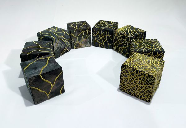 Barbara Schneider - Golden Veins (Eight black fabric boxes covered in stitched gold veins. They are arranged in a semi-circle)