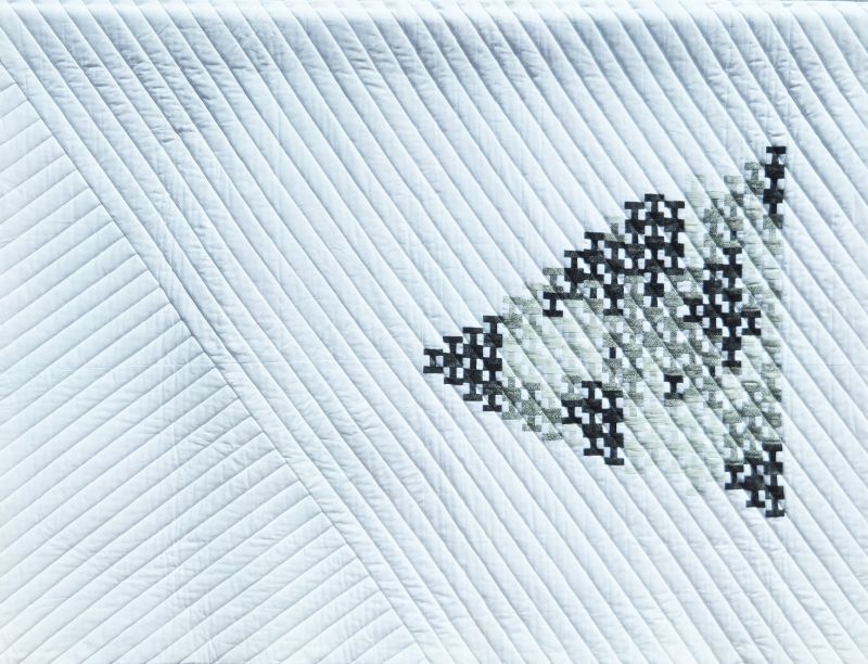 Shelley Koss - Nonconformist Goose (white background with diagonal quliting, black and white shapes form a triangle like a flock of geese)