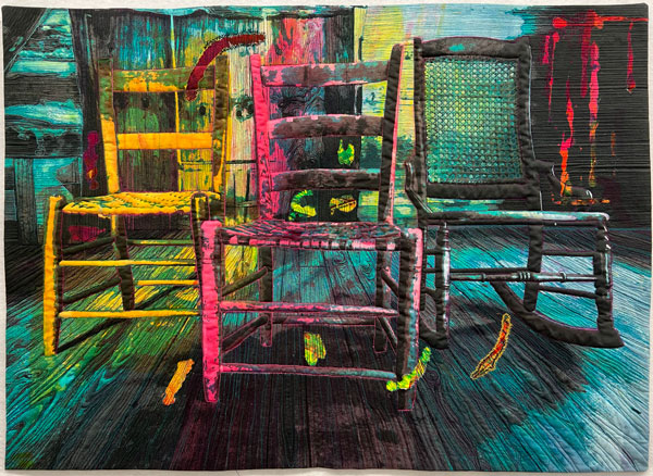 First Chair by Susan P Stevenson A quilt showing three chairs on a wood floor. The quilt uses bright tones of cyan, magenta, and yellow.