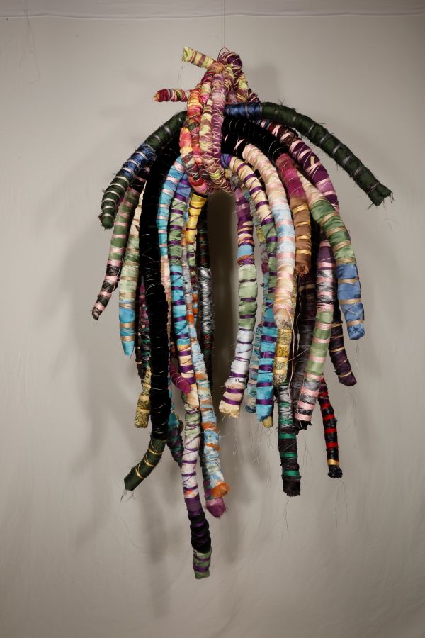 Connie Tiegel - Bound Memories (A sculpture made of colorful fabric ropes, they are bound with thread and also bound together with more ropes.)