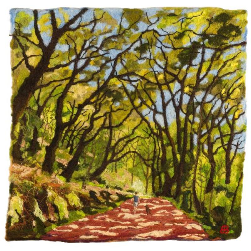 Birgitta Bower - Cathedral Trees, 2023, wool, yarn, and embroidery thread on linen, 30 x 27.5 inches (textile scene of a person and dog walking down a path surrounded by trees)