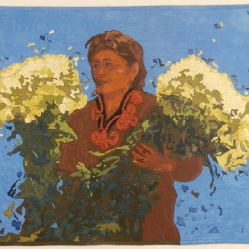 Kathleen McCabe - Woman With Flowers (a quilted portrait of a woman holding large flower bouquets on blue ground)