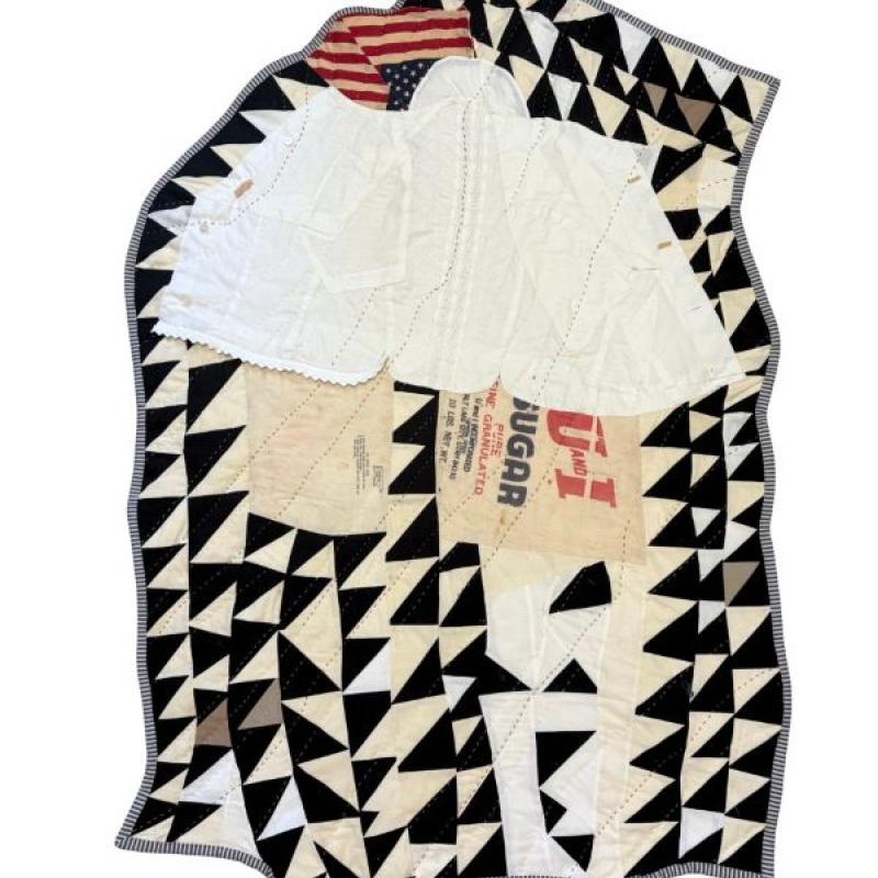Adie Kleckner - The cloth holds the memory of the body (irregular shaped quilt with black and white triangles, segment of American flag, white and advertising fabric)