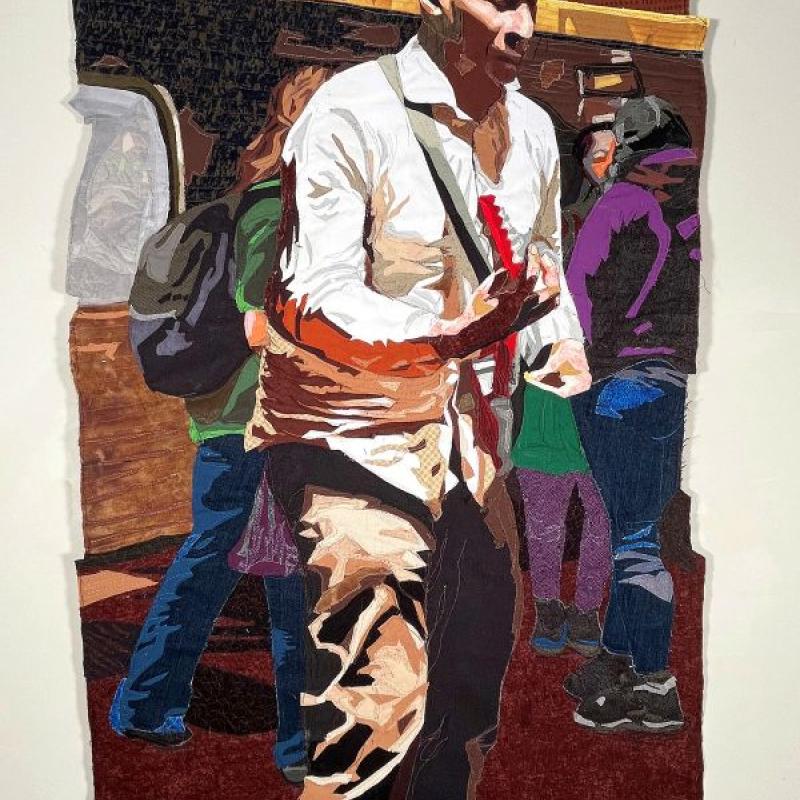 Jayne Bentley Gaskins - Subway Musician (quilted portrait of a man playing electric guitar in a crowded subway station)