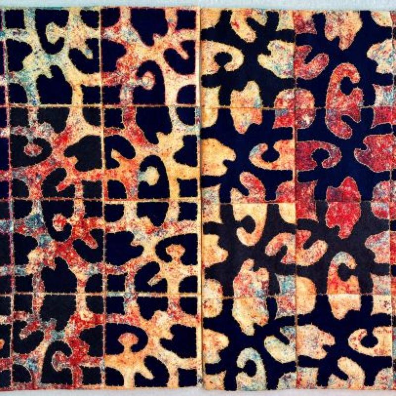 Dianne Miller Wolman - Counterchange Diptych (a quilt with abstract black shapes over yellow and red background on one side and the reverse on the other made of squares stitched together)