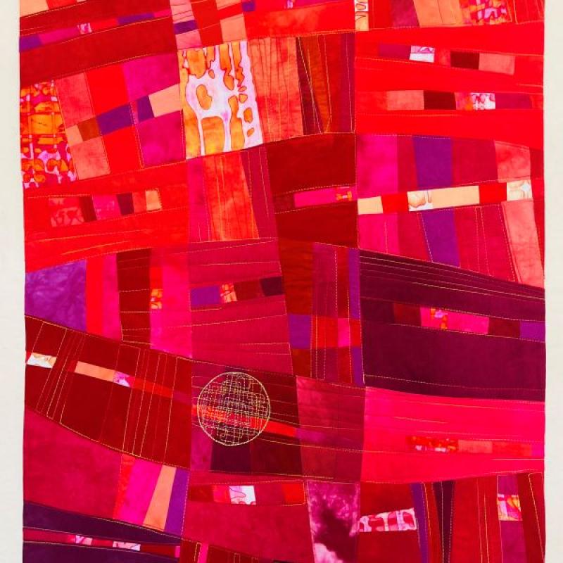 Anne Bellas - Final Aria (Quilt made of rectangles and shades of red, pink and orange.)