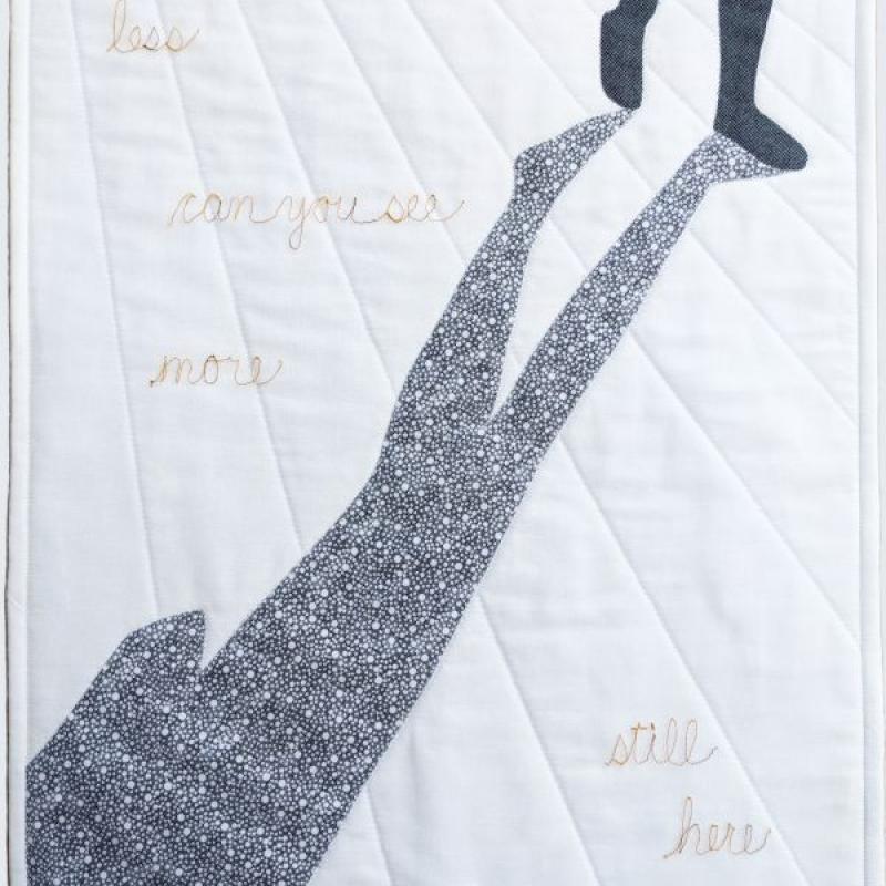 Lee McLean - Still Here (quilt with silhouette and shadow of legs walking. text reads less can you see more still here)