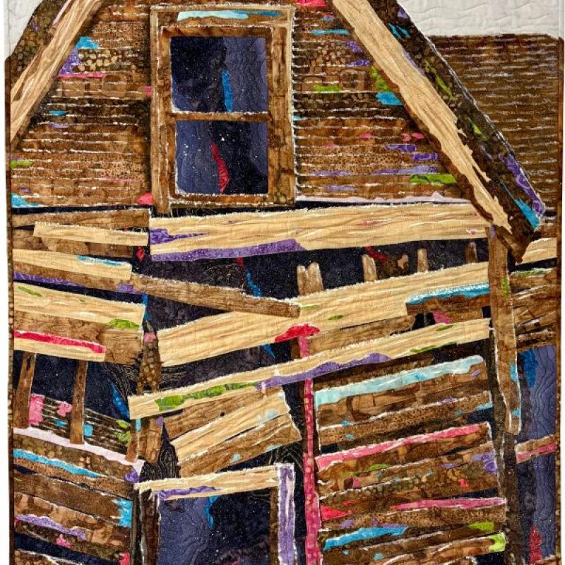 Michelle Jackson - Standing Alone (a quilt depicting a dilapidated house with bright colors peeking out from between the boards)
