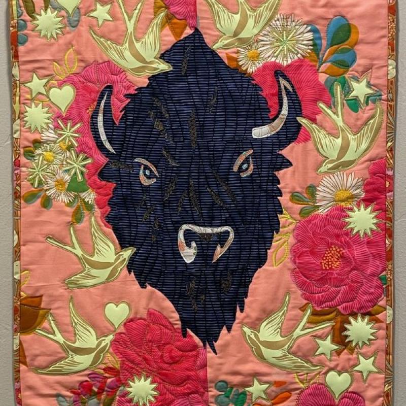 Audrey Hyvonen - Shield Maiden with Swallow Tail Signs (quilt portrait of bison on background of flowers and birds)